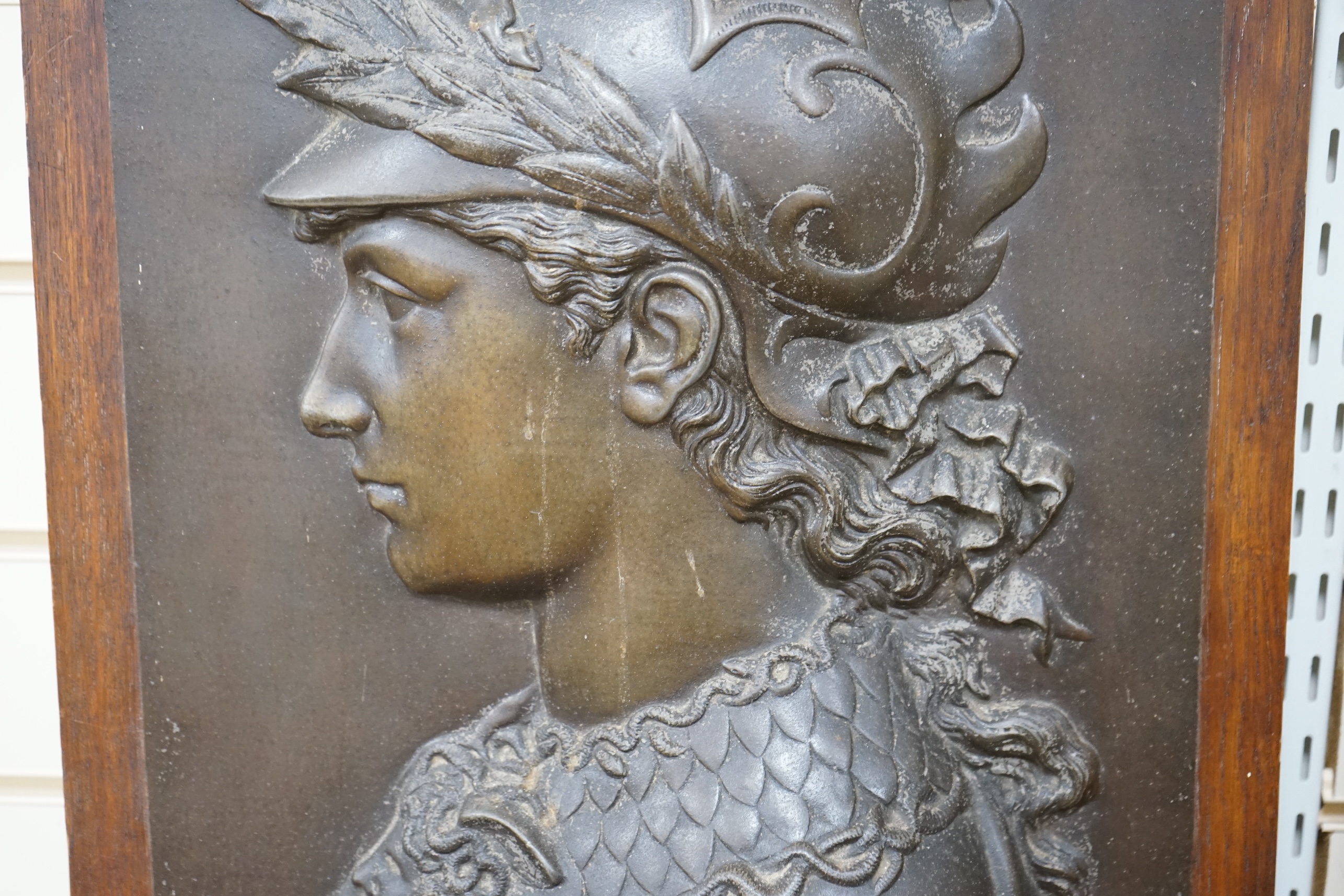 After Edmond Louis Charles Tassel (French, fl. 1870-1900), a bronzed metal bas-relief plaque with the bust of Perseus, mounted on an oak panel, circa 1900. Relief 49.5 cm high x 35cm wide. Condition - poor